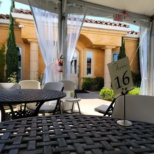 a patio with tables and chairs