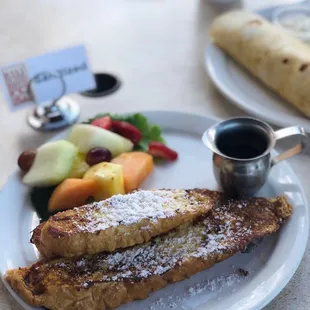Orange French Toast with side of fresh fruit on the outdoor patio