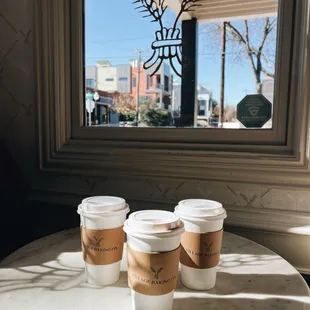 three cups of coffee on a table