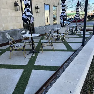a patio with chairs and umbrellas