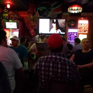 a group of people watching televisions