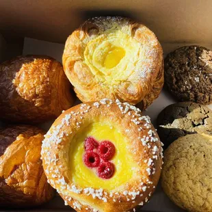 Clockwise: pain au chocolat, cheese danish &amp; lemon curd, salted choco rye, choco chunk, snickerdoodle, fruit brioche, pain au chocolate.
