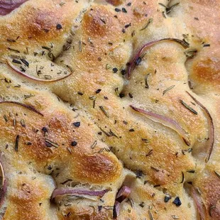 a slice of bread with onions and herbs