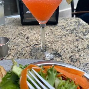 a plate of salad and a martini