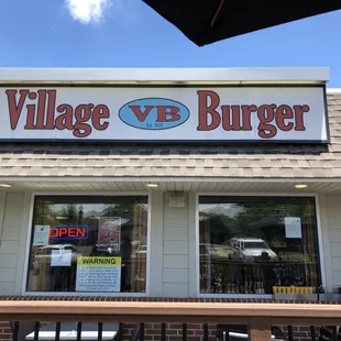 Village Burger sign in the storefront.