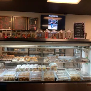 a man standing in front of a display of pastries