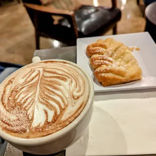 a cup of coffee and a pastry