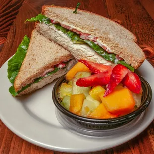 Homemade chicken salad on freshly baked bread with fruit