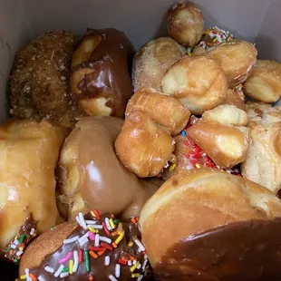 a box of doughnuts with chocolate frosting and sprinkles