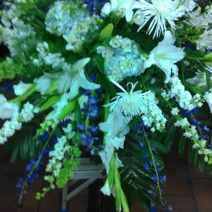 Blue and white casket spray.