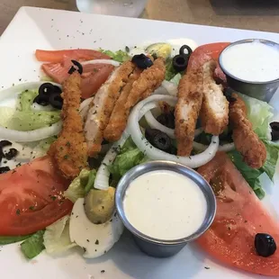a plate of salad with dressing