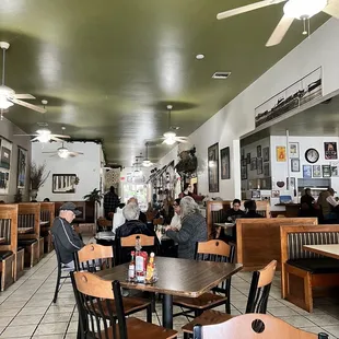 people sitting at tables in a restaurant