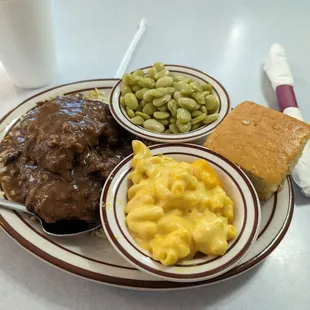 Country style steak with mac and cheese, lima, beans, and cornbread