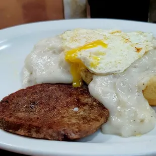 Sausage gravy and biscuit with egg and sausage patty