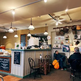 people sitting at tables in a cafe