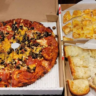 Pepperoni &amp; olives pizza, garlic chips (back right) &amp; garlic bread (upfront on the right)