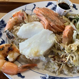 a plate of seafood, rice and vegetables