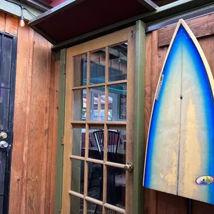 a surfboard hanging on a wall