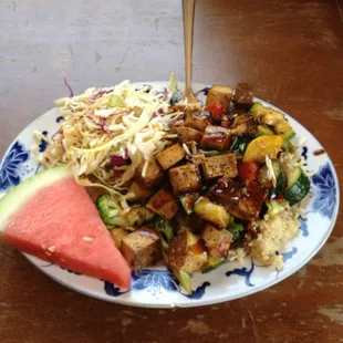 Tofu stir-fry over brown rice. Side of slaw with Asian-inspired dressing. Yum!