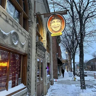 a man's face on a sign on a building