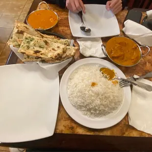 Butter Chicken (right), Tikka Masala (top left), Garlic Naan Bread, and Plain Rice