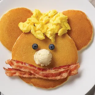 Buttermilk Pancake Brunch, three buttermilk pancakes with two cherrywood-smoked bacon strips or two sausage links with flavored maple syrup