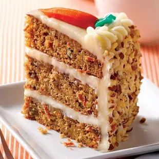 Carrot Cake - two-layer cake with shredded carrots, pineapple, sweetened coconut and pecan pieces, cream cheese frosting, and walnuts.