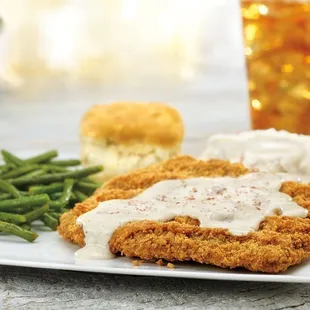 Homestyle Chicken-Fried Steak, smothered in country sausage gravy, served with mashed potatoes, choice of one side and a buttermilk biscuit