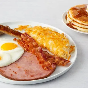 Signature 2-2-2 Breakfast! Two eggs, any style, two cherrywood-smoked bacon strips or two sausage links and two buttermilk pancakes.