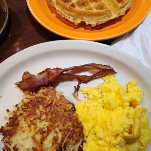 waffles, eggs, bacon and hash browns