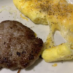 Sausage, burned on the bottom, with omelet. Asked for American cheese but given some 3 cheese shredded blend.