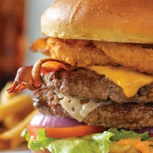 All-World Double Cheeseburger, American + Swiss cheese on 2 burgers with smoked bacon strips, onion rings, and Thousand Island dressing.