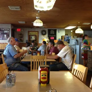 people sitting at tables in a restaurant