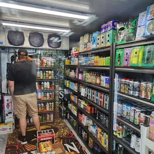 a man standing in the aisle of a store