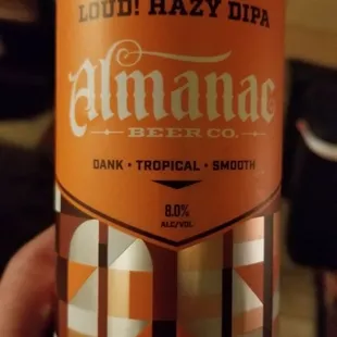 a hand holding a can of beer