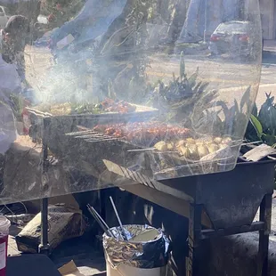 a man cooking food on a grill