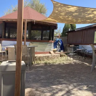 a patio area with tables and chairs