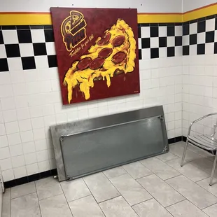 a large piece of pizza on the wall