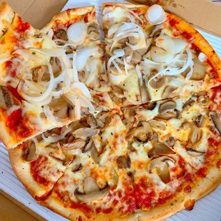 a pizza with mushrooms, onions, and cheese