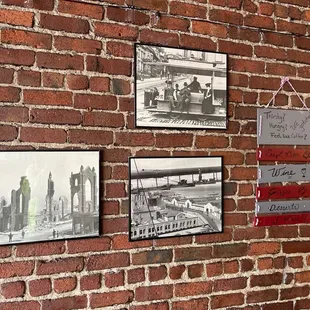a brick wall with pictures on it