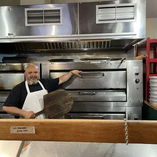 Luis at the helm. Oven are turned on 2 hours before baking to get the perfect heat for the pizza.