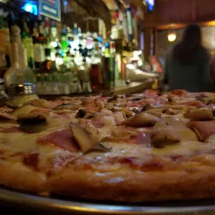 a pizza with mushrooms and ham