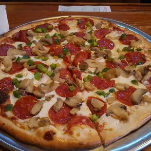 a pizza with pepperoni and mushrooms