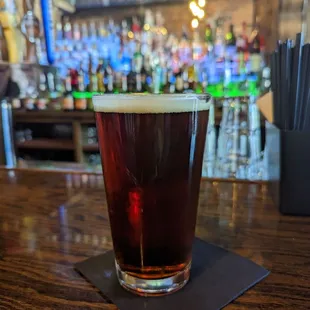 a pint of beer on a bar