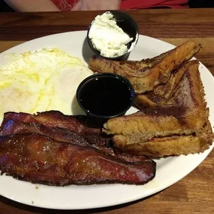 French toast, side over eggs and bacon.