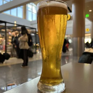 a glass of beer on a counter