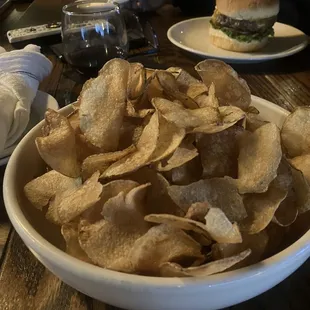 a bowl of chips and a burger