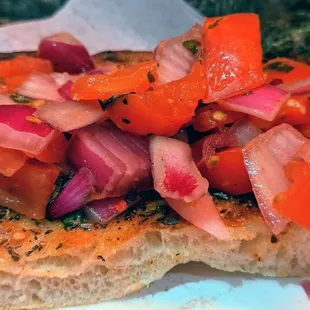 Bruschetta slice. (Vegetarian) Lots of red onions