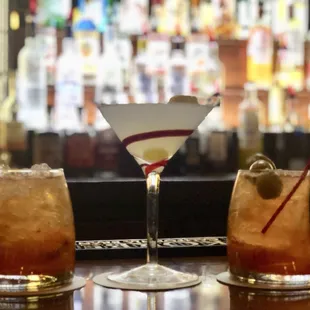 three cocktails on a bar