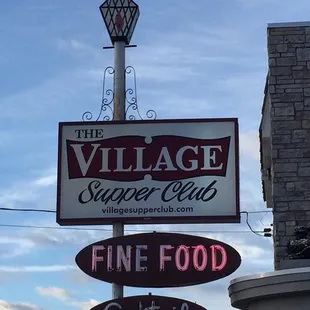 the sign for the village supper club